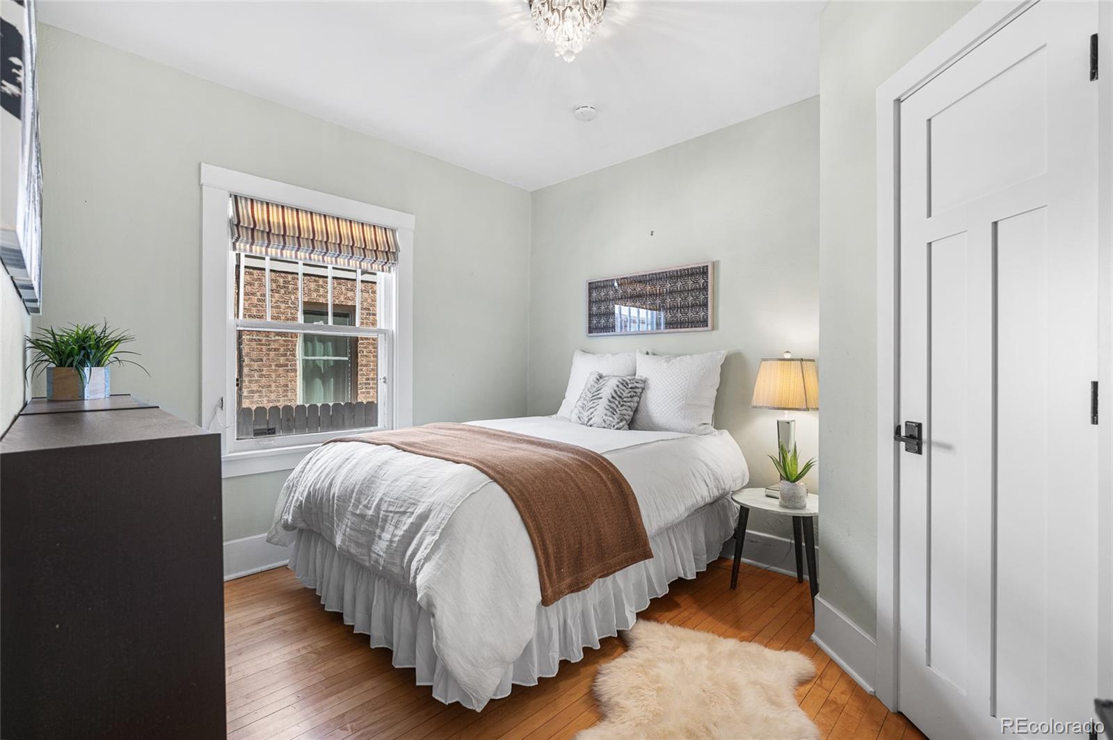 1065 Jackson Street Denver, CO 80206 - Photo 22 of 50 a bedroom with a bed and a potted plant