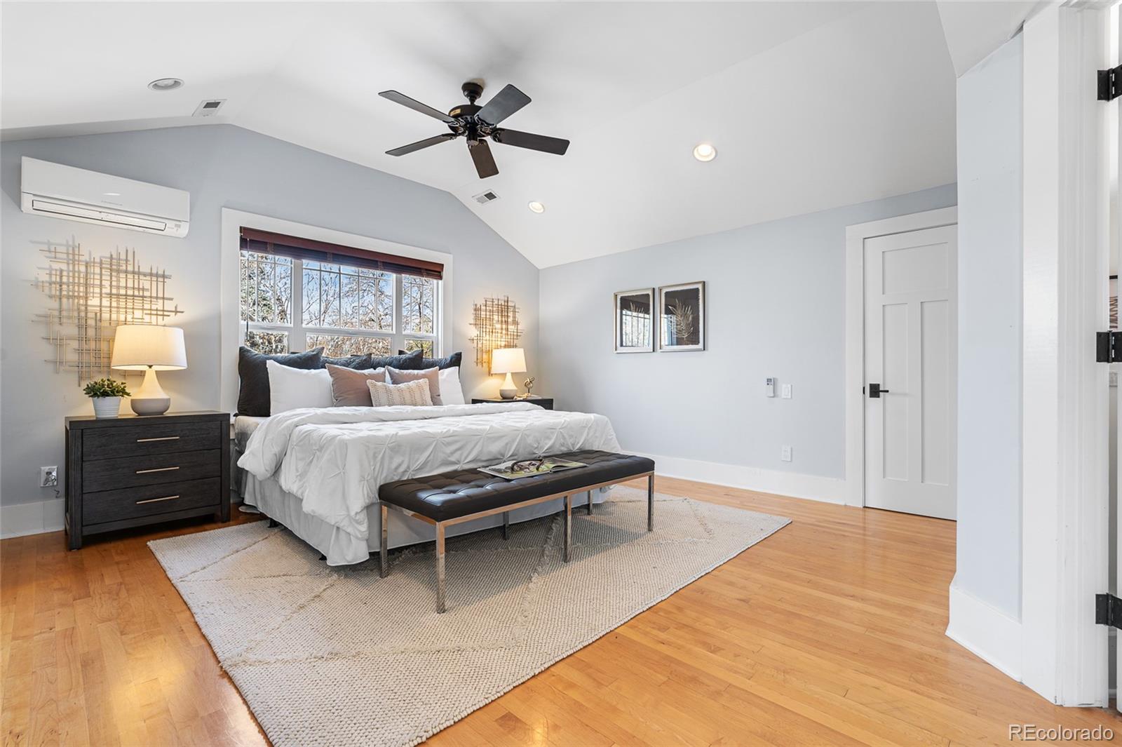 1065 Jackson Street Denver, CO 80206 - Photo 29 of 50 a bedroom with a bed and wooden floor