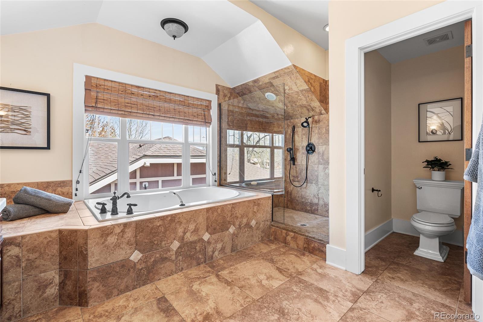 1065 Jackson Street Denver, CO 80206 - Photo 30 of 50 a large bathroom with a tub and a large window
