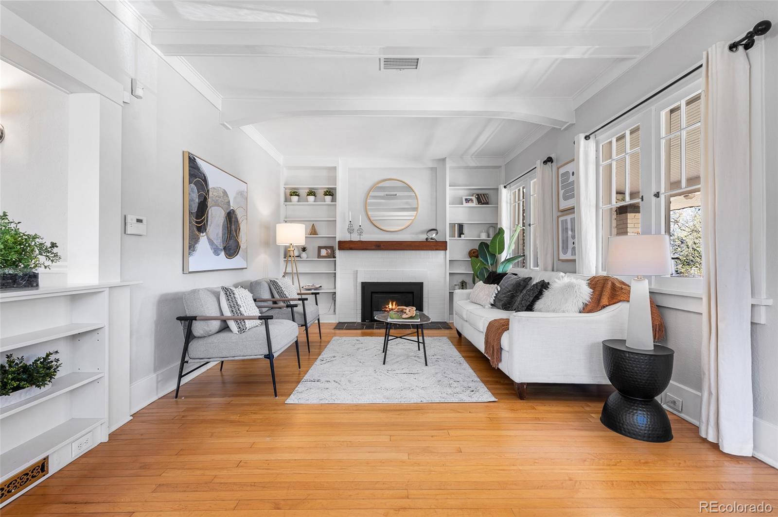 1065 Jackson Street Denver, CO 80206 - Photo 3 of 50 a living room with furniture and a fireplace