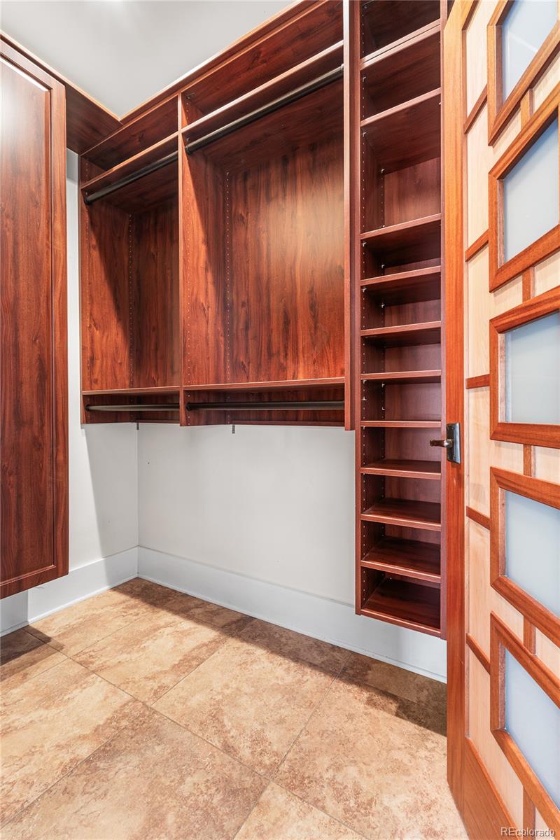 1065 Jackson Street Denver, CO 80206 - Photo 32 of 50 a view of walk in closet with clothes and shoes