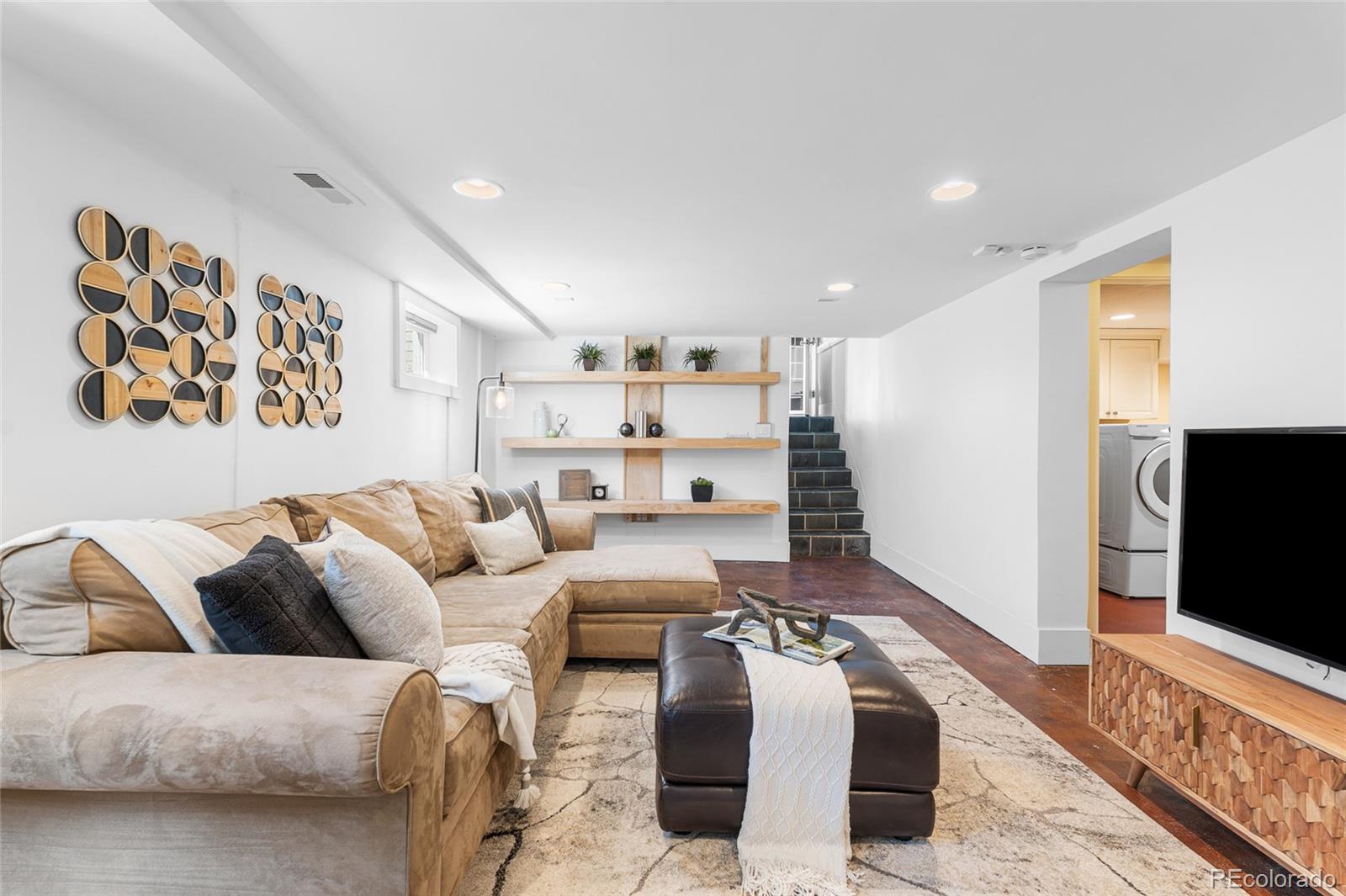 1065 Jackson Street Denver, CO 80206 - Photo 35 of 50 a living room with furniture and a flat screen tv