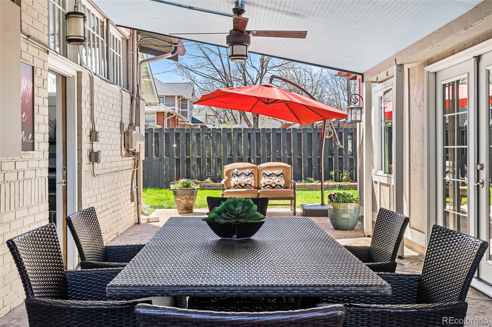 1065 Jackson Street Denver, CO 80206 - Photo 39 of 50 a view of a dining room with furniture a chandelier and wooden floor