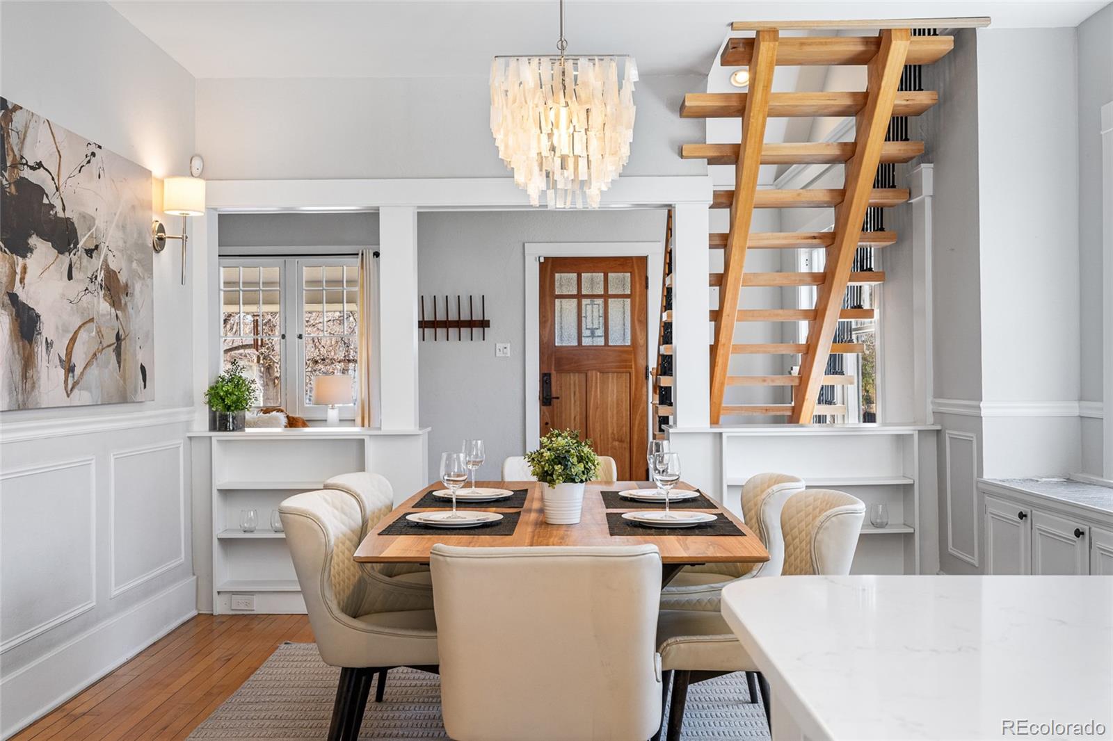1065 Jackson Street Denver, CO 80206 - Photo 8 of 50 a view of a dining room with furniture a chandelier and wooden floor