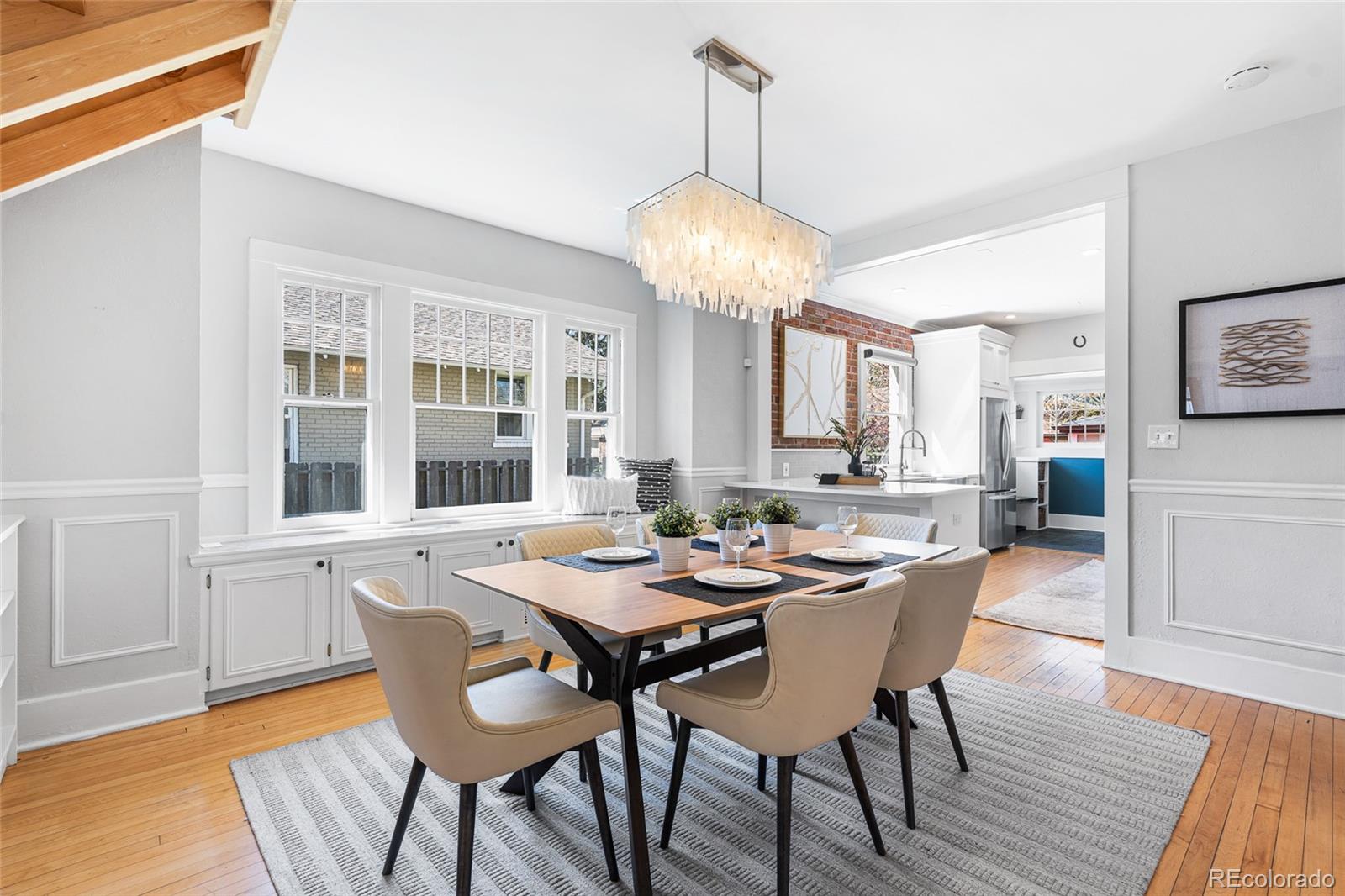 1065 Jackson Street Denver, CO 80206 - Photo 9 of 50 a view of a dining room with furniture wooden floor and chandelier