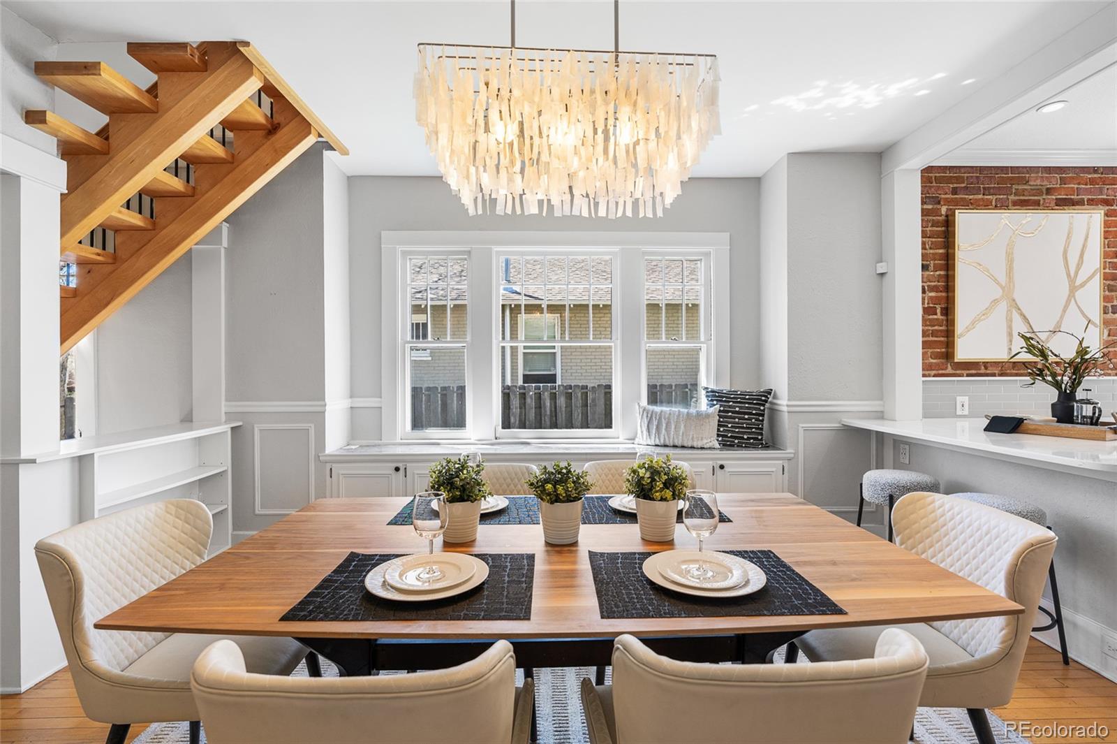 1065 Jackson Street Denver, CO 80206 - Photo 10 of 50 a view of a dining room with furniture a chandelier and wooden floor