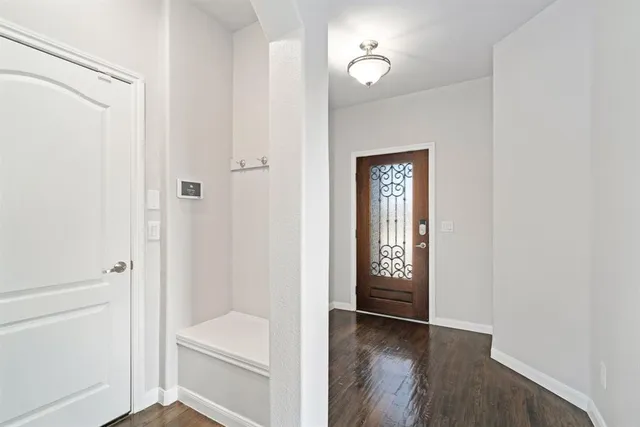 a hallway with window and wooden floor