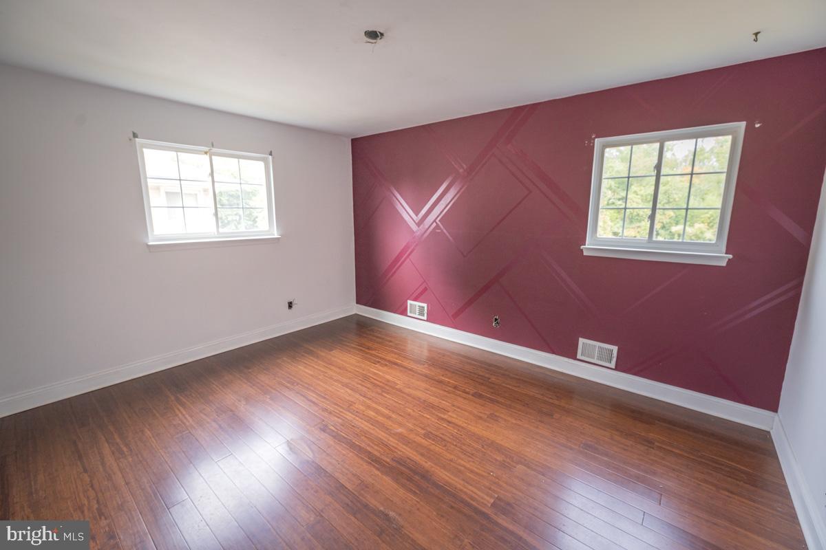892 Estates Boulevard Hamilton, NJ 08690 - Photo 23 of 36 a view of an empty room with wooden floor and a window
