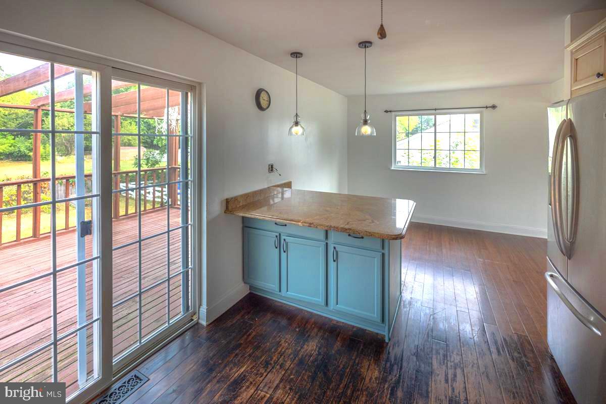 892 Estates Boulevard Hamilton, NJ 08690 - Photo 10 of 36 a kitchen with kitchen island wooden floors and wide window