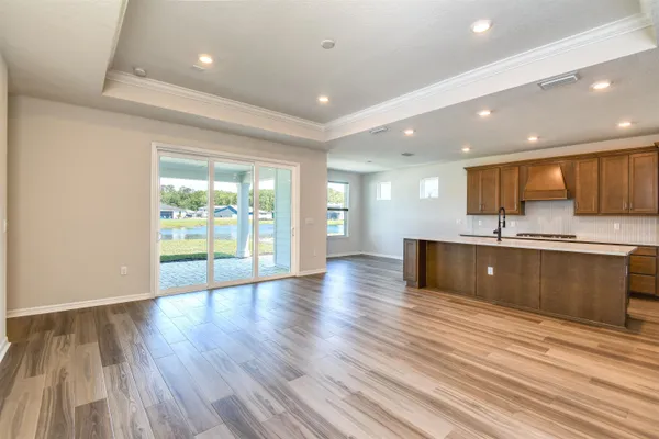 a large kitchen with stainless steel appliances granite countertop a large counter top a sink and a refrigerator