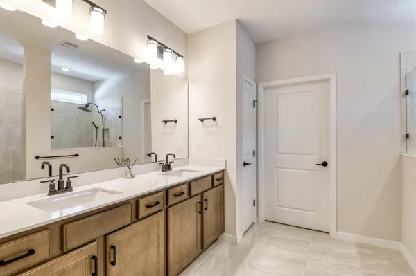 a spacious bathroom with a double vanity sink mirror and