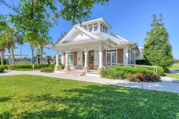 a front view of a house with garden and porch