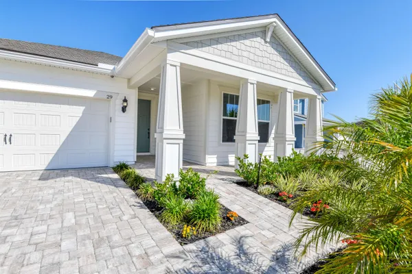 a view of a house with potted plants