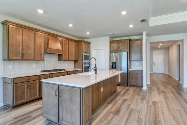 a kitchen with a sink stove and cabinets