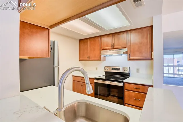 a kitchen with wooden cabinets and a stove top oven
