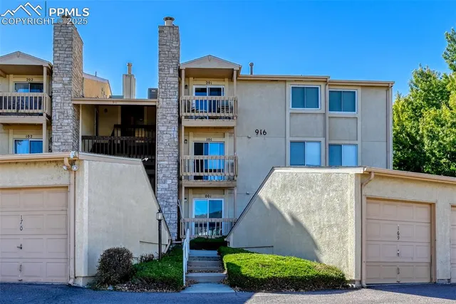 a view of a brick house with large windows
