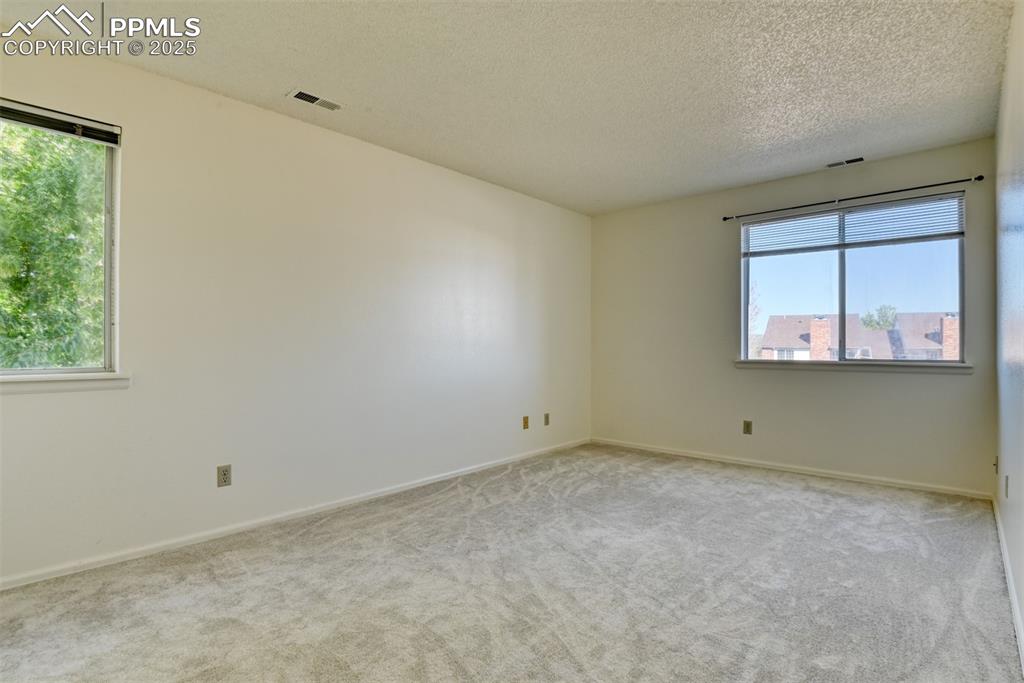 916 Tenderfoot Hill Road, Unit 101 Colorado Springs, CO 80906 - Photo 23 of 42 an empty room with windows