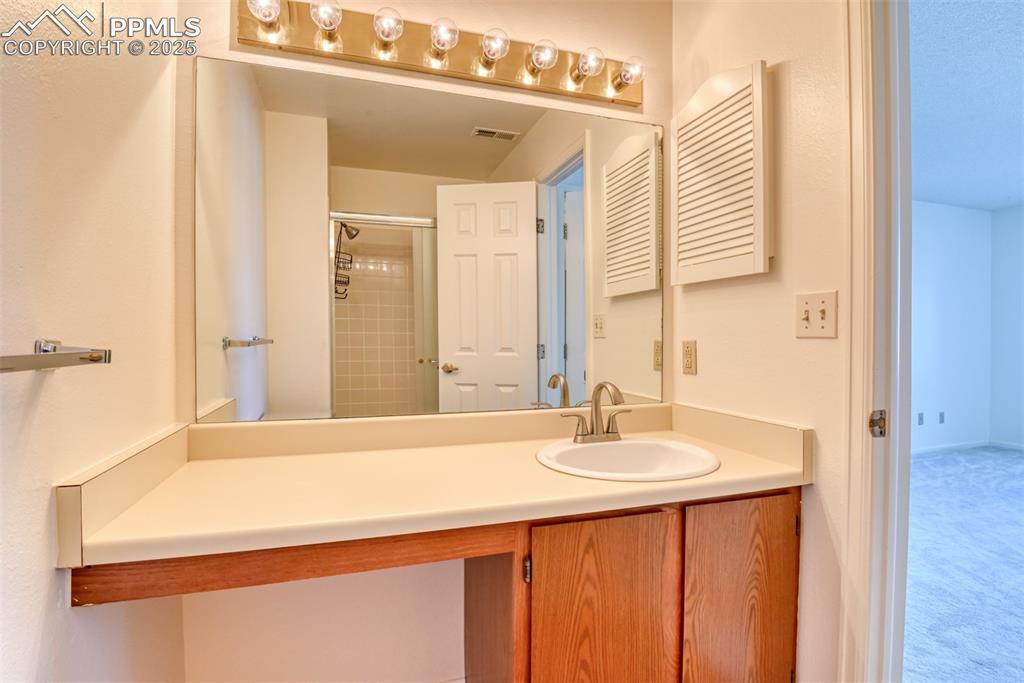 916 Tenderfoot Hill Road, Unit 101 Colorado Springs, CO 80906 - Photo 29 of 42 a bathroom with a sink and a mirror