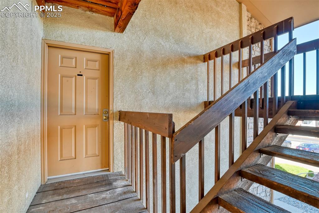 916 Tenderfoot Hill Road, Unit 101 Colorado Springs, CO 80906 - Photo 4 of 42 a view of staircase with lots of frames on wall and windows