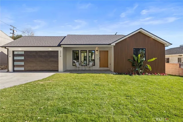 a view of a house with a yard and garage