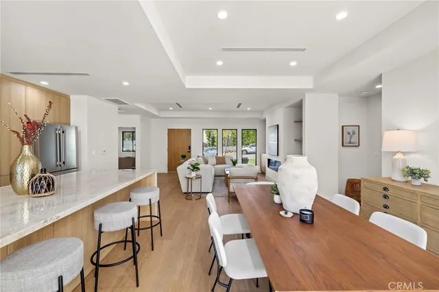 a living room with furniture flat screen tv and large window
