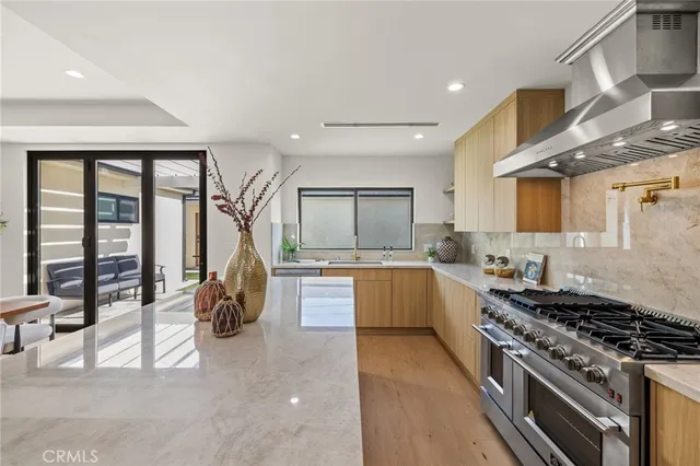 a large kitchen with a large window and stainless steel appliances