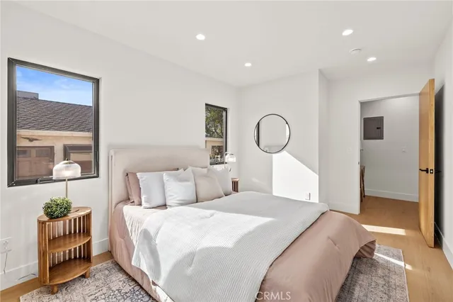 a bedroom with a bed and a mirror