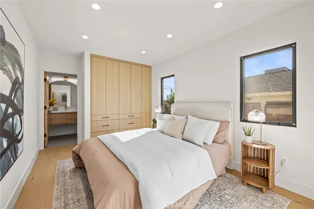 a bedroom with a bed and a painting on the wall