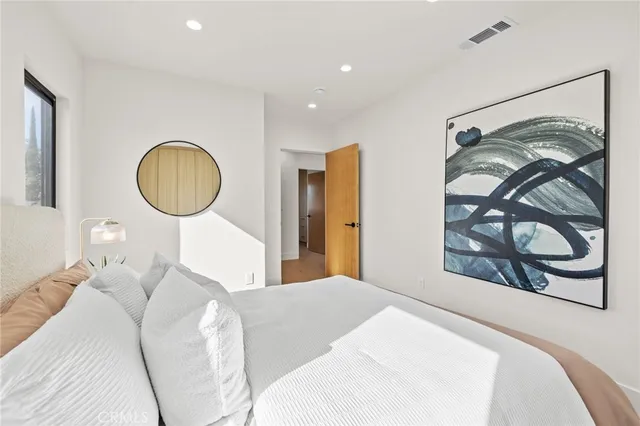 a bathroom with a bathtub shower sink vanity mirror and toilet