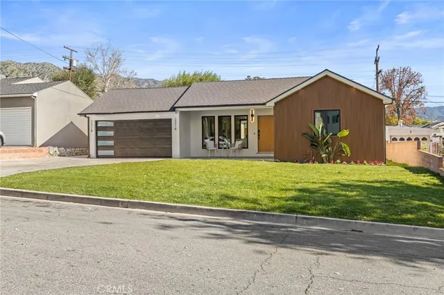 a front view of house with yard and green space