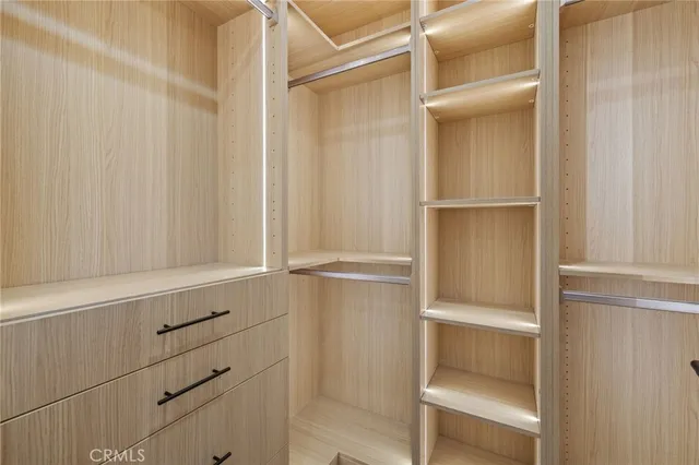a view of kitchen with refrigerator and window