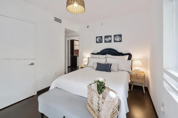 a bathroom with a granite countertop sink a mirror and a shower
