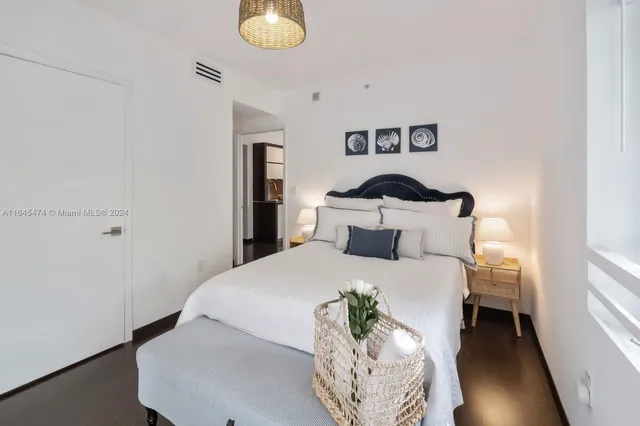 a bathroom with a granite countertop sink a mirror and a shower