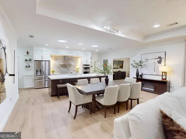 a dining room with furniture a fireplace and wooden floor