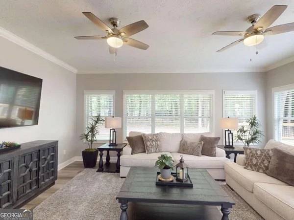 a living room with furniture and a large window