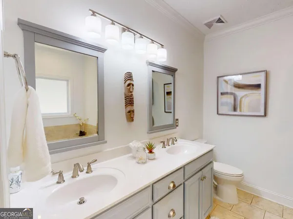 a bathroom with a toilet sink and shower curtain