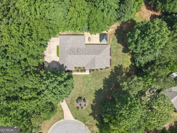an aerial view of a house with a yard
