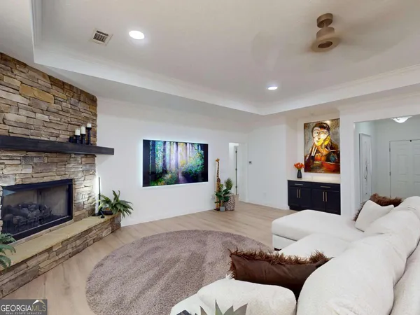 a living room with furniture and a fireplace