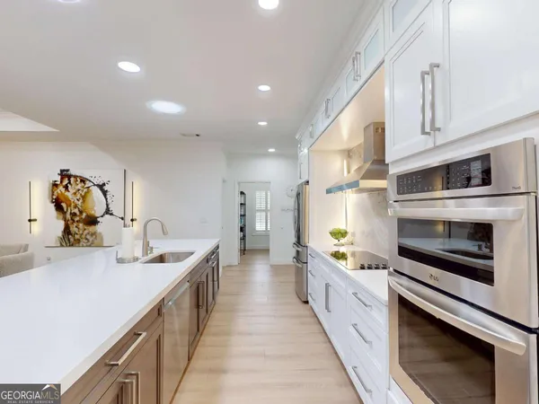 a kitchen with stainless steel appliances a stove microwave and cabinets