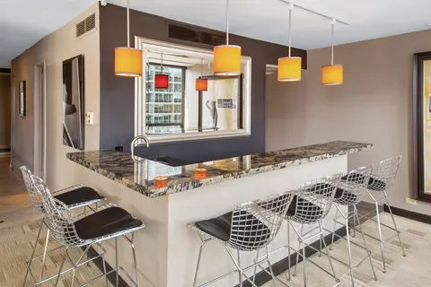 a kitchen with stainless steel appliances kitchen island granite countertop a stove a sink and a microwave