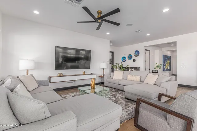 a kitchen with kitchen island a stove a table and chairs in it