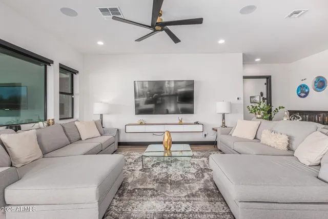 a dining room with furniture a chandelier and wooden floor