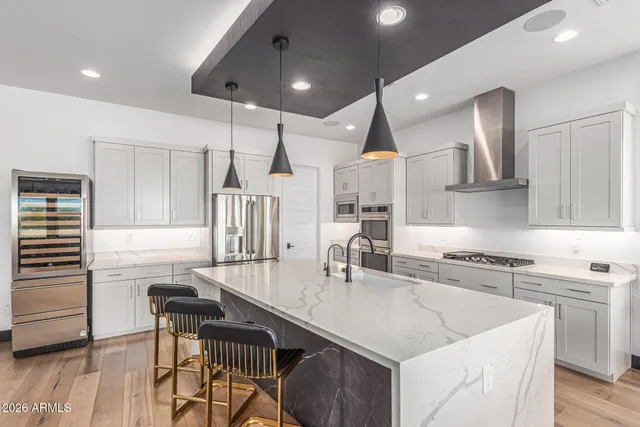 a bathroom with a double vanity sink a large mirror a bathtub and window