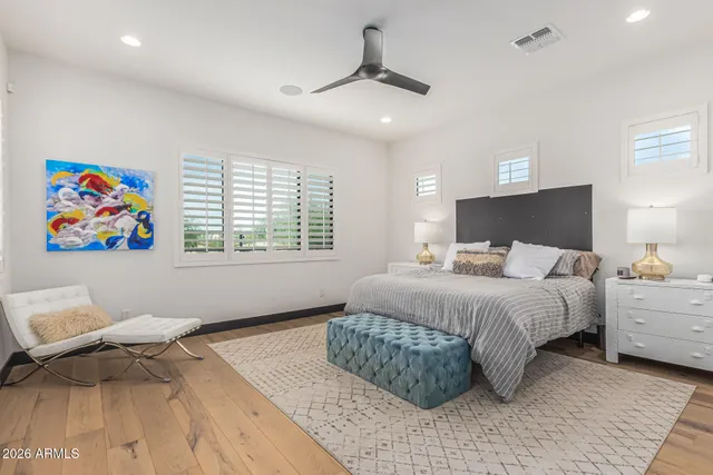 a bedroom with a bed and a lamp on table