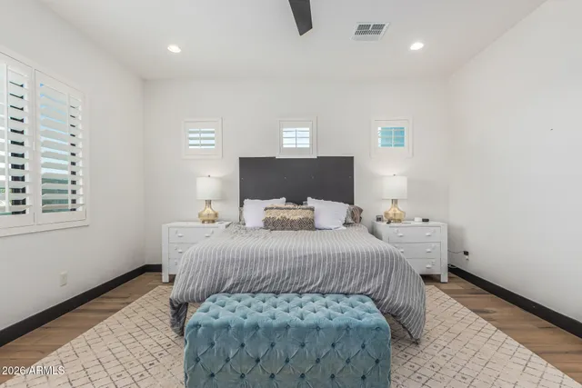 a bedroom with a bed and a mirror