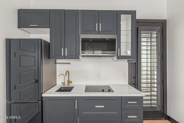 an aerial view of residential houses with outdoor space and parking