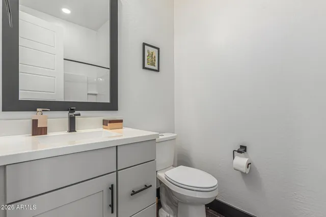 a patio table and chairs with potted plants and big trees