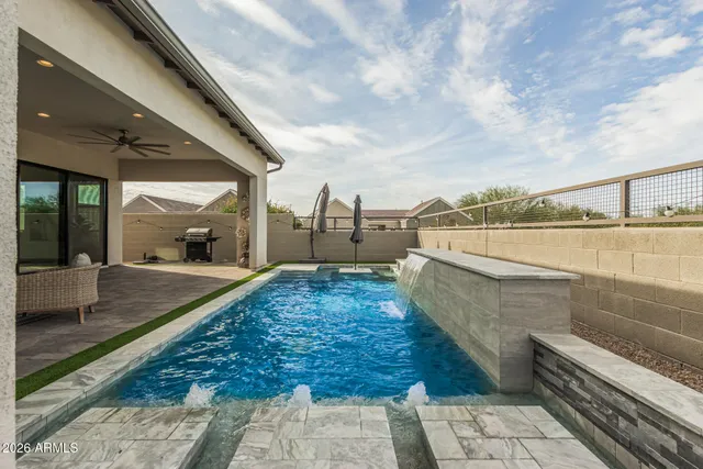 a living room with lots of furniture and view of kitchen