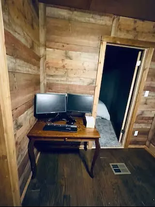 a view of a patio with table and chairs and wooden floor