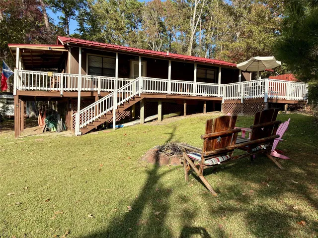 a view of a house with backyard porch and sitting area